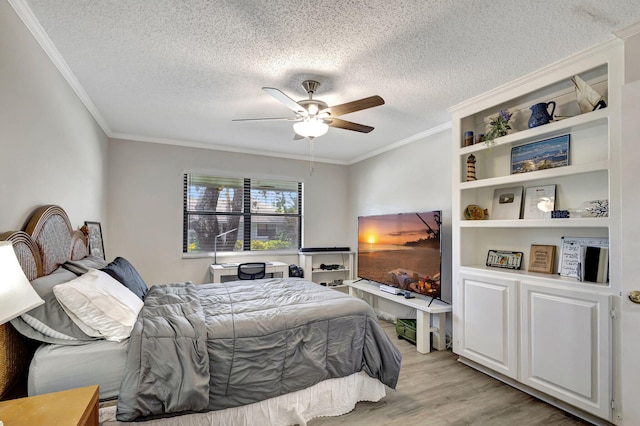 bedroom featuring light hardwood / wood-style flooring, ornamental molding, a textured ceiling, and ceiling fan