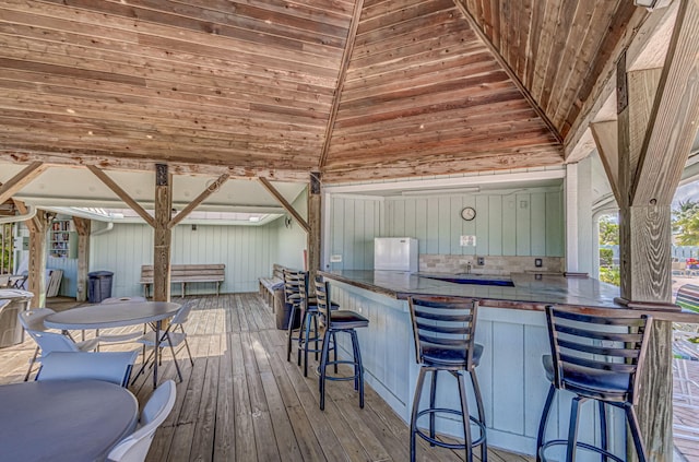 wooden terrace with an outdoor bar