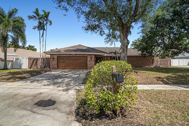 100 SW 15th Ct, Boca Raton, FL 33486 - ranch-style home with fence, a tiled roof, a garage, concrete driveway, and a front yard