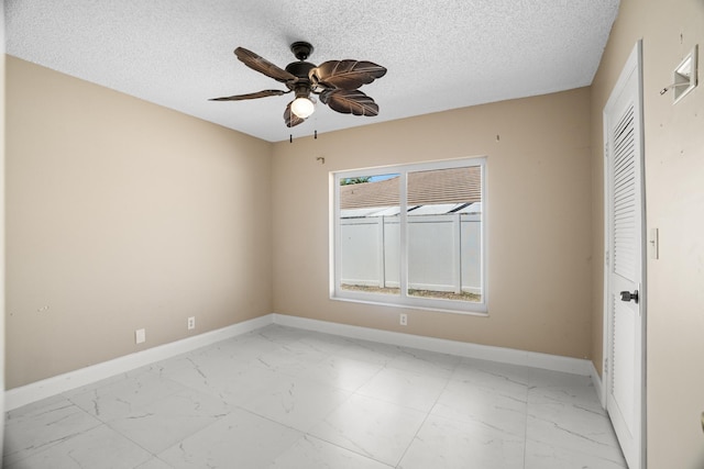 100 SW 15th Ct, Boca Raton, FL 33486 - spare room with baseboards, marble finish floor, and ceiling fan