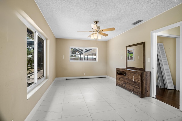 100 SW 15th Ct, Boca Raton, FL 33486 - spare room with a textured ceiling, marble finish floor, baseboards, visible vents, and ceiling fan