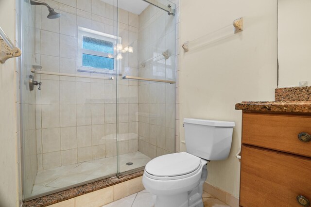 100 SW 15th Ct, Boca Raton, FL 33486 - bathroom featuring toilet, vanity, tile patterned flooring, and a shower stall