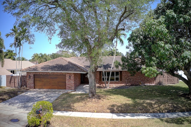 100 SW 15th Ct, Boca Raton, FL 33486 - ranch-style house featuring fence, a tiled roof, a garage, brick siding, and driveway