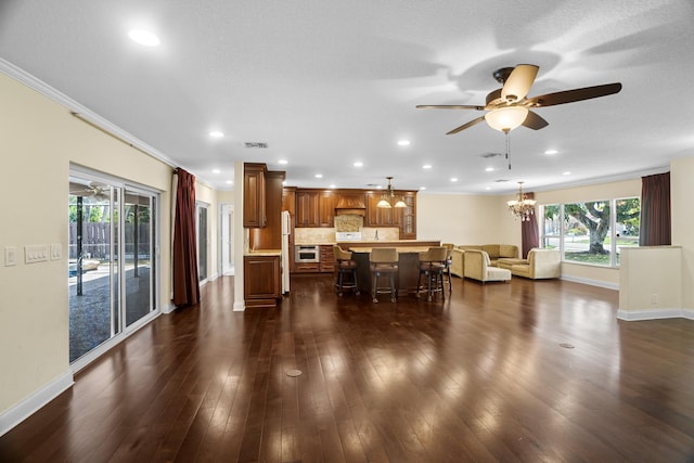 100 SW 15th Ct, Boca Raton, FL 33486 - interior space with ceiling fan with notable chandelier, ornamental molding, dark wood-style floors, and baseboards