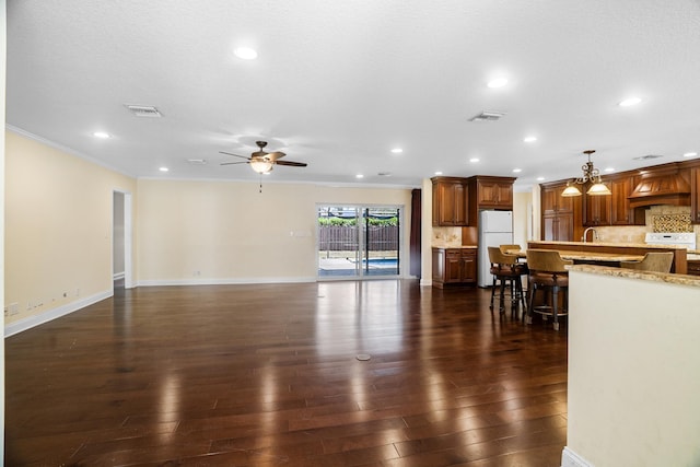 100 SW 15th Ct, Boca Raton, FL 33486 - living area with dark wood-type flooring, ceiling fan, visible vents, and ornamental molding