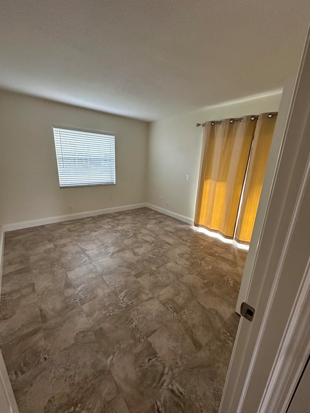 empty room featuring a textured ceiling