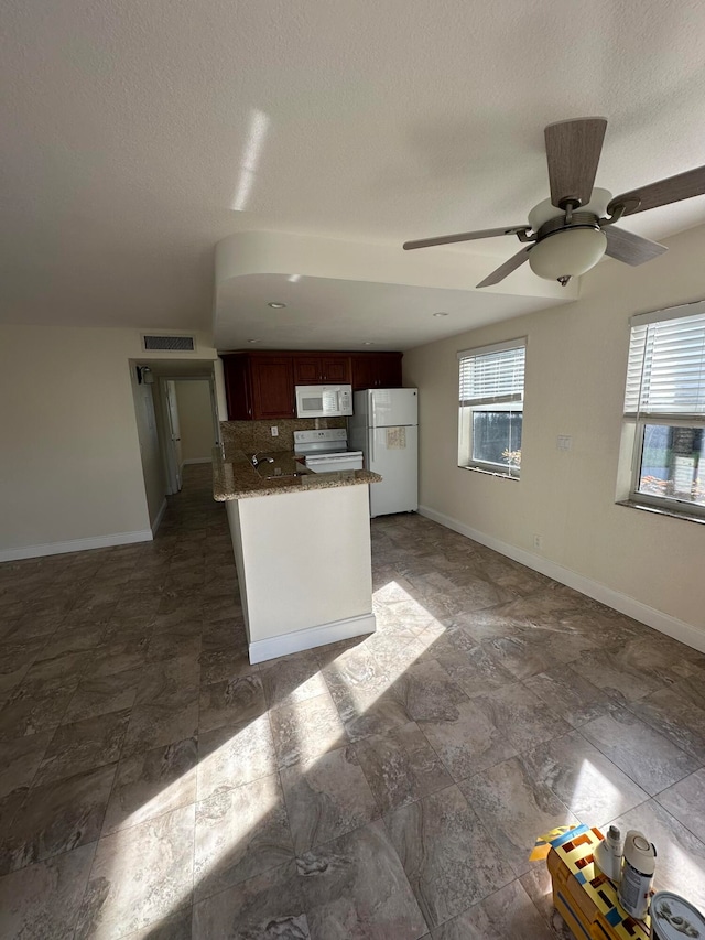 kitchen with a textured ceiling, tasteful backsplash, ceiling fan, and white appliances