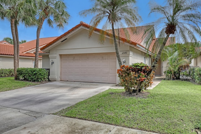 view of front facade featuring a front yard and a garage