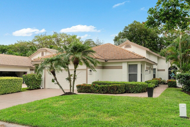 mediterranean / spanish house with a front yard and a garage