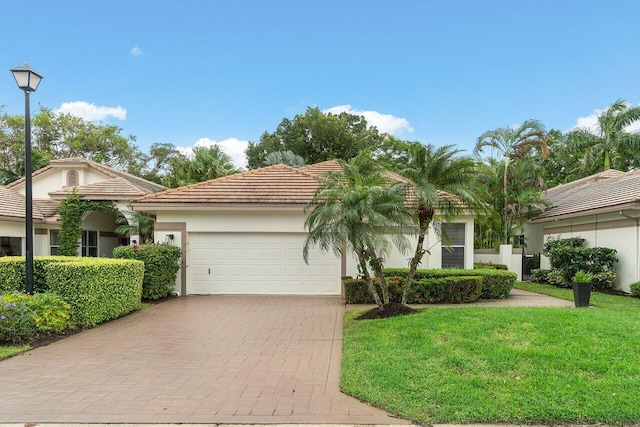 view of front facade with a front lawn and a garage