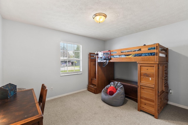 carpeted bedroom with a textured ceiling