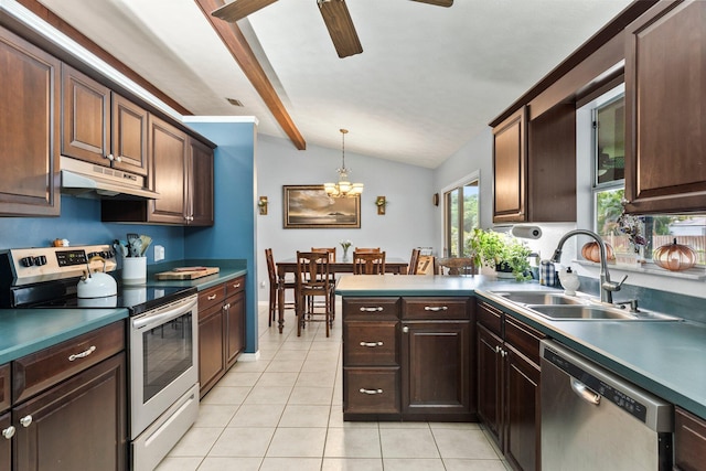 kitchen with appliances with stainless steel finishes, sink, light tile patterned floors, pendant lighting, and lofted ceiling