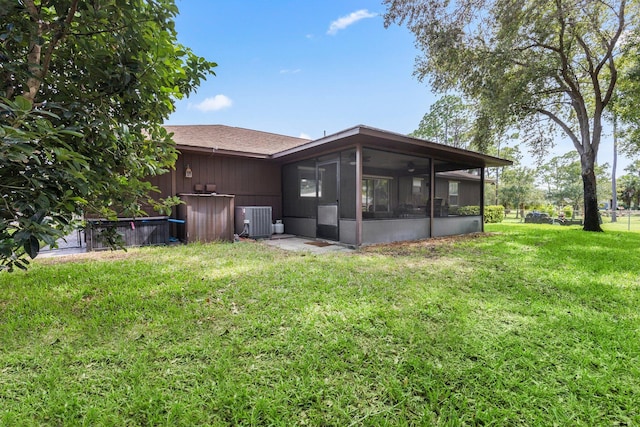 view of yard with a sunroom and central AC unit