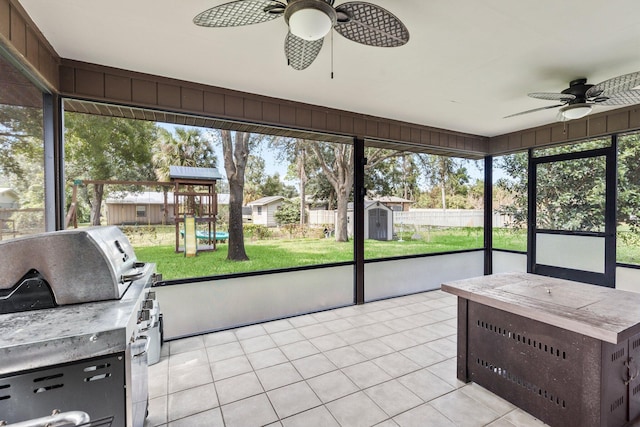 sunroom / solarium featuring ceiling fan