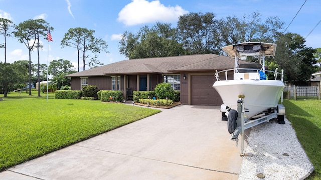 view of front of house featuring a garage and a front yard