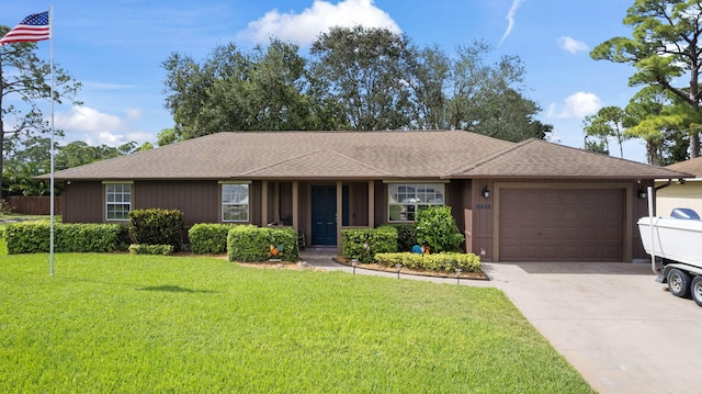 single story home featuring a front yard and a garage