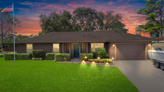 ranch-style home with a lawn and a garage