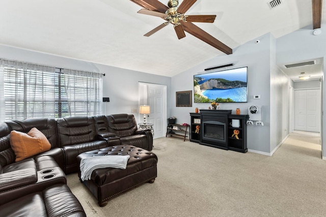 living room with a fireplace, vaulted ceiling with beams, light colored carpet, and ceiling fan