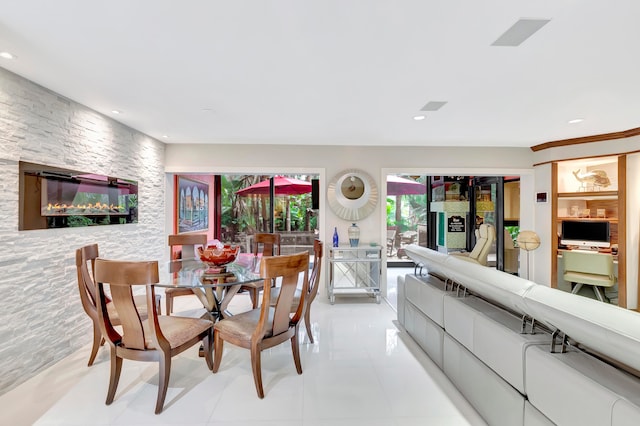 tiled dining room with a fireplace