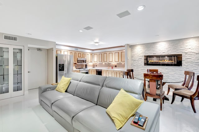 living room with a stone fireplace