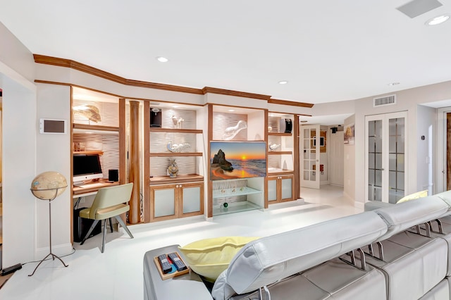 living room with french doors, built in desk, and ornamental molding