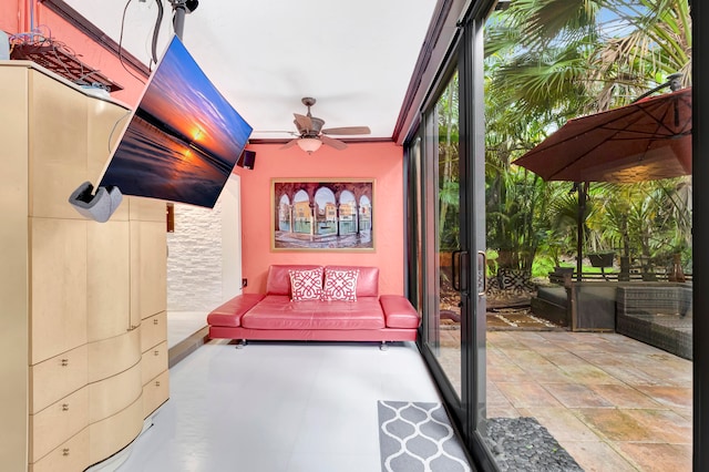 unfurnished sunroom featuring ceiling fan