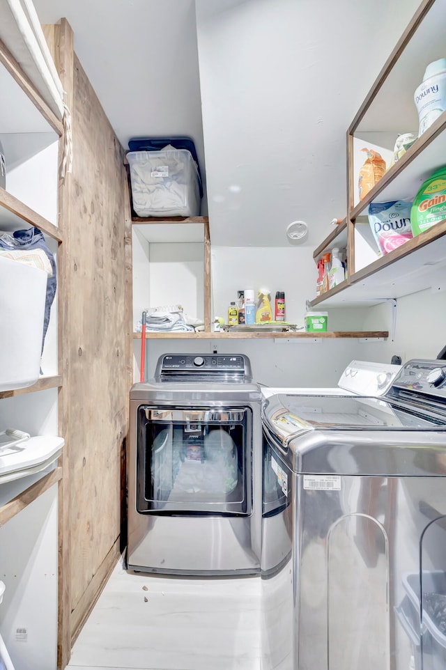 washroom featuring light hardwood / wood-style floors and separate washer and dryer