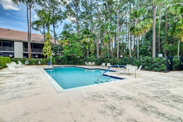 view of swimming pool with a patio area