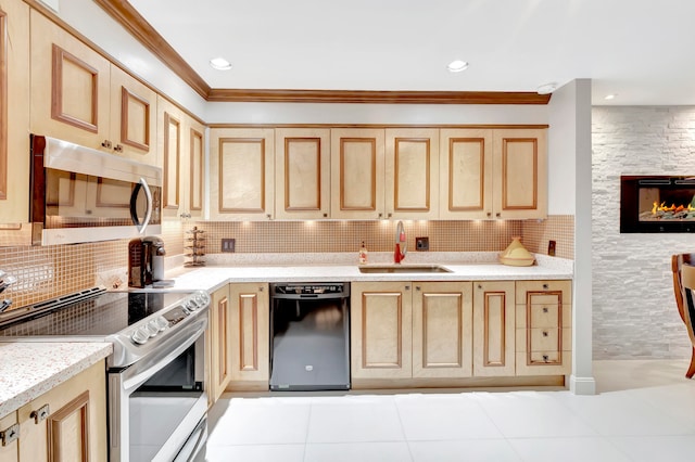 kitchen with light brown cabinetry, stainless steel appliances, ornamental molding, and sink