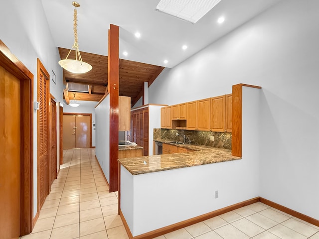 kitchen featuring kitchen peninsula, backsplash, high vaulted ceiling, hanging light fixtures, and light tile patterned flooring