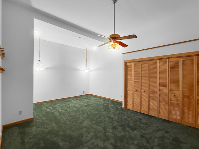 unfurnished bedroom featuring dark colored carpet and ceiling fan