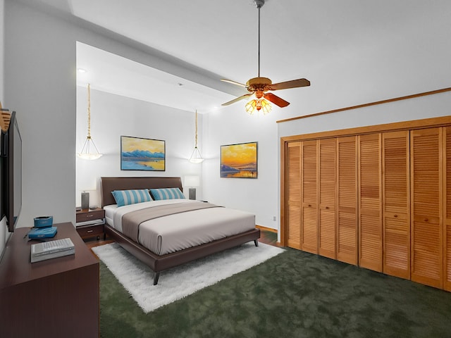 bedroom featuring dark colored carpet, ceiling fan, and a closet