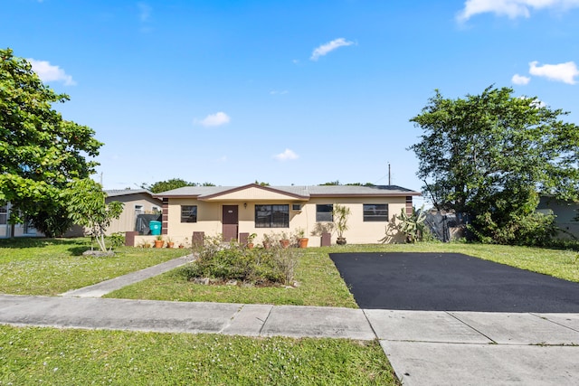 ranch-style home with a front yard