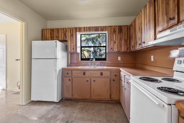 kitchen featuring white appliances, ventilation hood, and sink