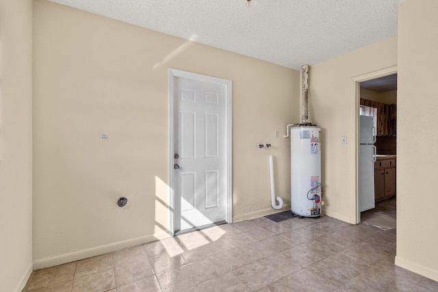 interior space with water heater and a textured ceiling