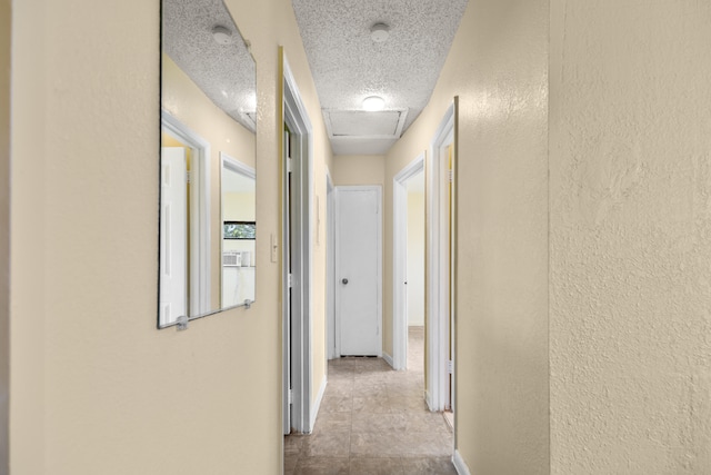 hallway featuring a textured ceiling