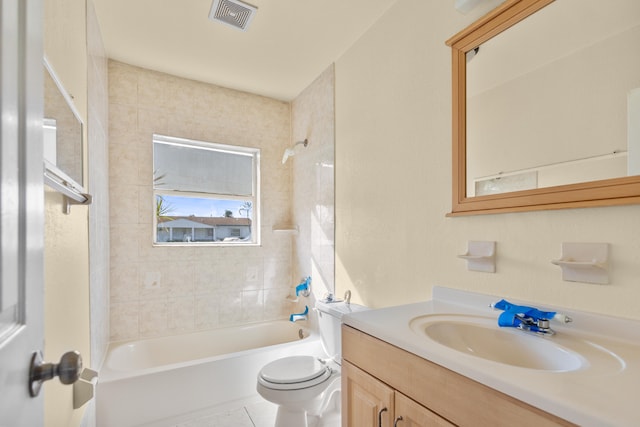 full bathroom featuring toilet, tiled shower / bath combo, vanity, and tile patterned flooring