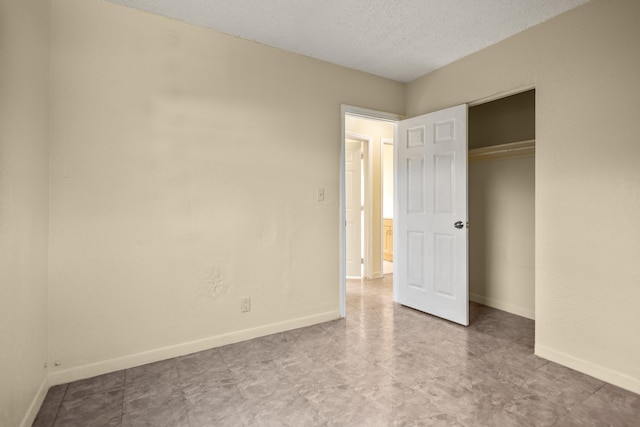 unfurnished bedroom with a textured ceiling and a closet