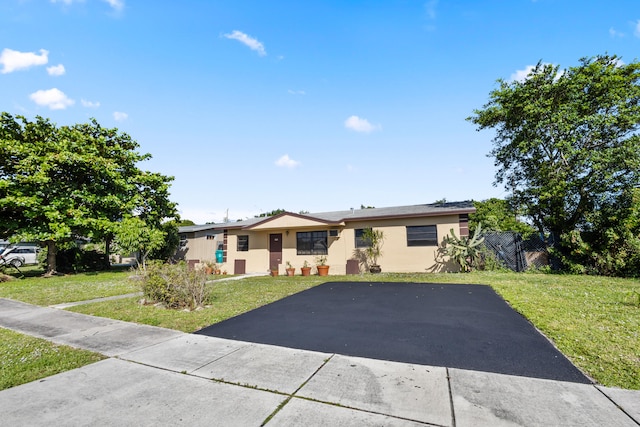 ranch-style home with a front yard