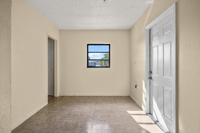 spare room with a textured ceiling