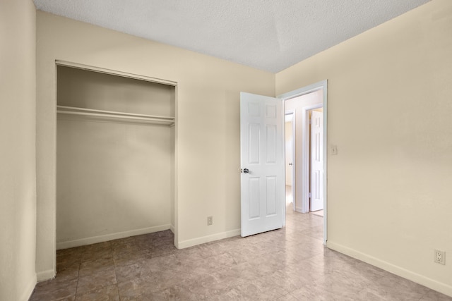 unfurnished bedroom with a closet and a textured ceiling