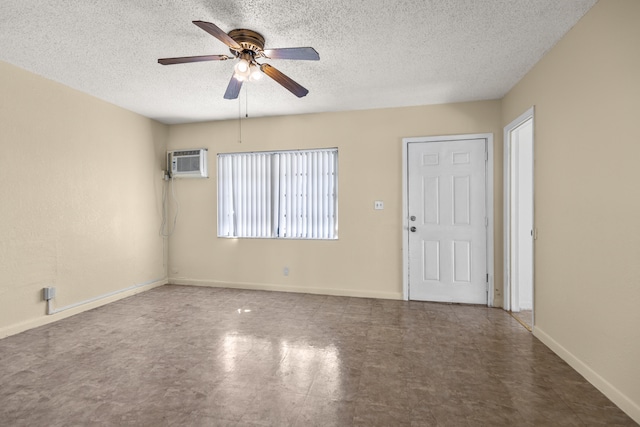 empty room with an AC wall unit, a textured ceiling, and ceiling fan