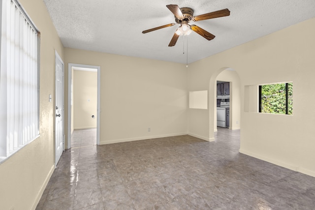 spare room with a textured ceiling and ceiling fan