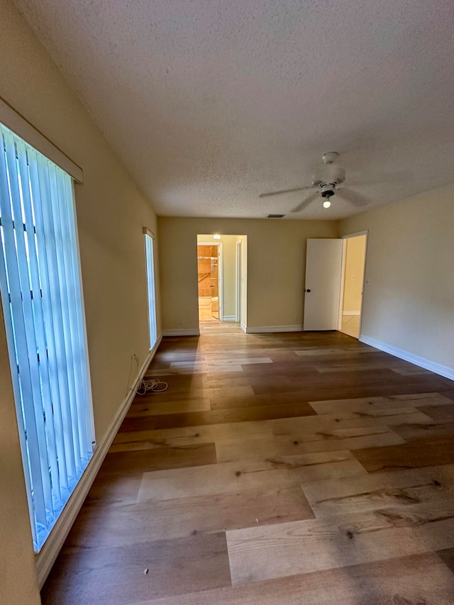 spare room featuring light hardwood / wood-style floors, a textured ceiling, and ceiling fan