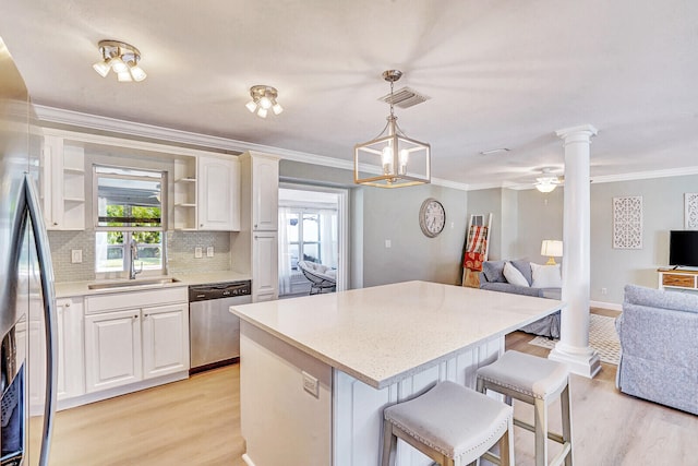 kitchen with a kitchen breakfast bar, white cabinets, stainless steel appliances, and light hardwood / wood-style floors