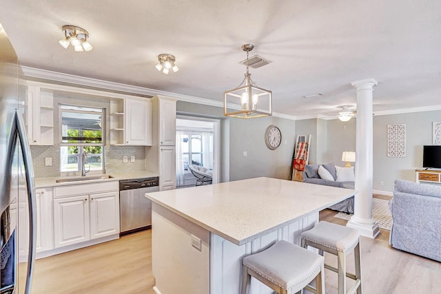 704 Eastwind Dr, North Palm Beach, FL 33408 - kitchen with decorative columns, open floor plan, appliances with stainless steel finishes, and a sink