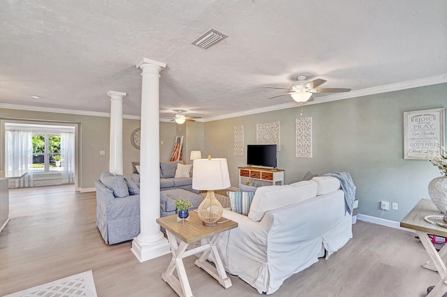 living room with ornamental molding, decorative columns, light wood-type flooring, and ceiling fan