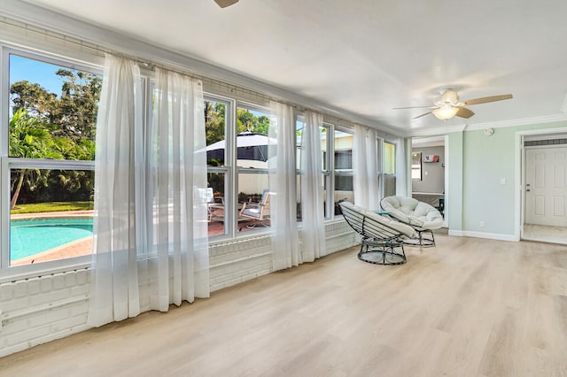 sunroom with ceiling fan and plenty of natural light