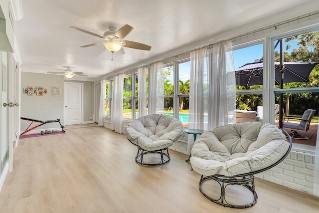 sunroom with ceiling fan and plenty of natural light