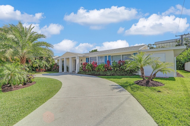 view of front facade with a front yard and a garage